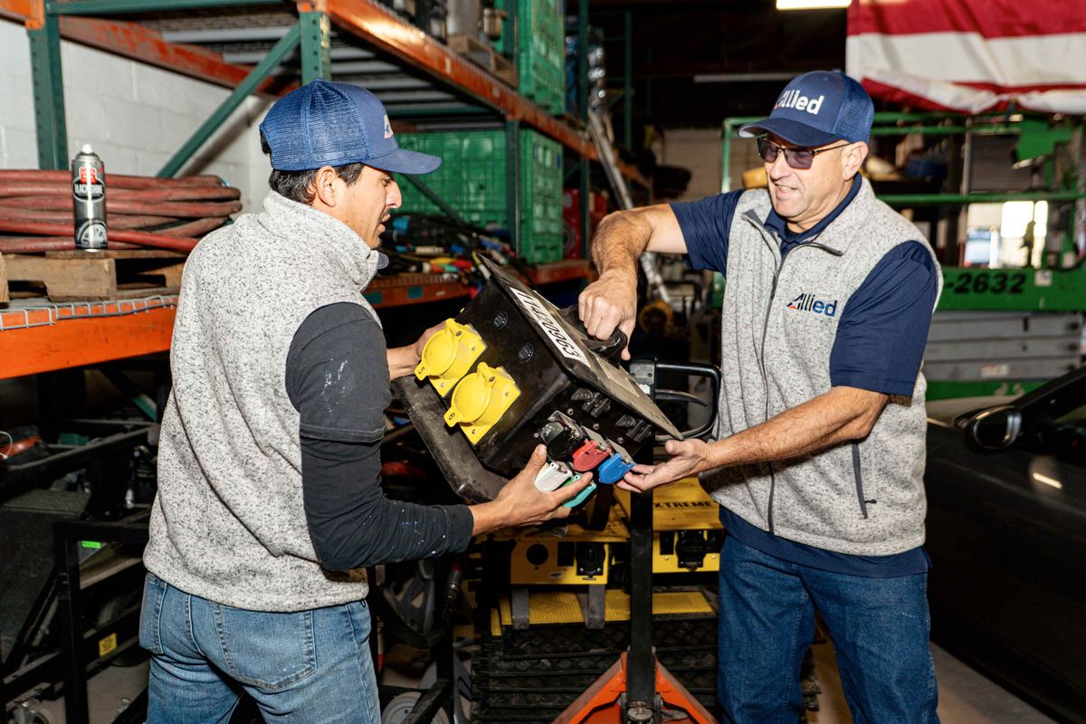 Allied Restoration technicians preparing emergency restoration equipment in warehouse